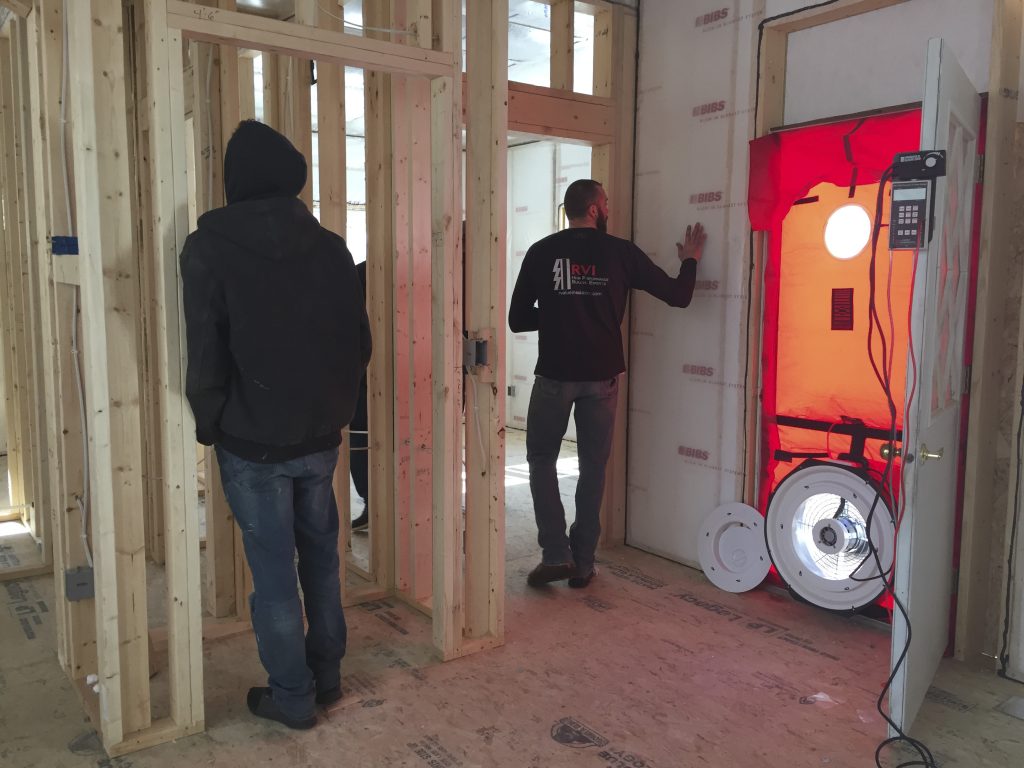 R-Value Insulators conducting a blower door test